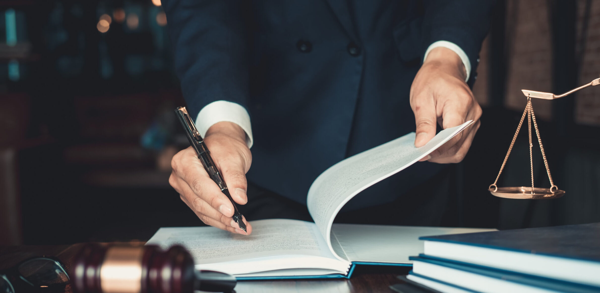 Justice and law concept. Gavel on sounding block in hand’s Male Justice and law concept. Gavel on sounding block in hand's Male judge at a courtroom, working with document law books, report the case on table in modern office.